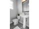 Bathroom featuring a pedestal sink, a toilet, and neutral-toned tiling at 2110 W Azeele St, Tampa, FL 33606