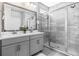 Stylish bathroom with double vanity, modern mirrors, and a glass-enclosed shower at 2110 W Azeele St, Tampa, FL 33606