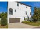 Three-story home boasts a private balcony, 2-car garage, modern design, and well-maintained landscaping at 2110 W Azeele St, Tampa, FL 33606