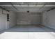 Spacious and organized two-car garage with epoxy flooring and ample storage shelving at 2110 W Azeele St, Tampa, FL 33606