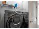 Modern laundry room equipped with Samsung washer and dryer, and overhead storage shelves at 2110 W Azeele St, Tampa, FL 33606