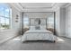 Bright main bedroom featuring a canopy bed, bedside tables, and neutral decor at 2110 W Azeele St, Tampa, FL 33606
