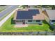 Aerial view of home featuring solar panels, patio, and lush backyard at 2211 Bay Berry Ln, Clearwater, FL 33763