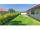 Well-maintained backyard featuring lush green grass and mature landscaping providing privacy at 2211 Bay Berry Ln, Clearwater, FL 33763