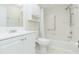 Bright bathroom featuring a shower-over-tub, modern sink, and white cabinets for storage at 2211 Bay Berry Ln, Clearwater, FL 33763