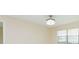 Neutral bedroom featuring a window and a decorative ceiling light fixture at 2211 Bay Berry Ln, Clearwater, FL 33763