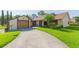 Charming single-story home with a well-maintained lawn and driveway leading to an attached garage at 2211 Bay Berry Ln, Clearwater, FL 33763