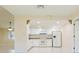 Open kitchen layout with white cabinets, white appliances, and tiled floor at 2211 Bay Berry Ln, Clearwater, FL 33763