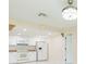 Modern kitchen with white appliances, white cabinets, and tiled backsplash at 2211 Bay Berry Ln, Clearwater, FL 33763