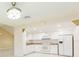 Bright kitchen with white cabinets, appliances, tile backsplash and granite countertops at 2211 Bay Berry Ln, Clearwater, FL 33763