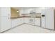 Well-lit kitchen featuring white cabinets and stainless steel appliances at 2211 Bay Berry Ln, Clearwater, FL 33763