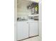 Compact laundry closet featuring modern washer and dryer units at 2211 Bay Berry Ln, Clearwater, FL 33763