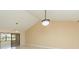 Bright living room featuring high ceilings, modern lighting, and a sliding glass door at 2211 Bay Berry Ln, Clearwater, FL 33763