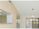 Open-concept living space with a bar pass-through to the kitchen and a view to the back patio at 2211 Bay Berry Ln, Clearwater, FL 33763