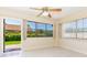 Inviting living area with large windows, outdoor views, and a ceiling fan at 2211 Bay Berry Ln, Clearwater, FL 33763