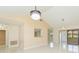 Spacious living room showcasing modern light fixtures, bar pass-through, and views to other living spaces at 2211 Bay Berry Ln, Clearwater, FL 33763