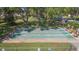Enjoy the community shuffleboard court surrounded by mature trees and benches for relaxing at 2211 Bay Berry Ln, Clearwater, FL 33763