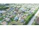 An aerial view of a single-Gathering home near a pond and situated in a well-maintained community with green lawns at 2214 132Nd E Pl, Parrish, FL 34219