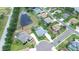 Aerial view of a home with a private pool and pond in a lush suburban setting at 2214 132Nd E Pl, Parrish, FL 34219