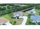 Aerial view of a well-kept single Gathering home with a pond view, nice landscaping, and a long driveway at 2214 132Nd E Pl, Parrish, FL 34219
