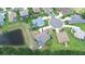 Aerial view of a home with a pool, pond, and well-maintained landscaping in a suburban neighborhood at 2214 132Nd E Pl, Parrish, FL 34219