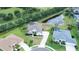An aerial view showcasing a home next to a pond within a green residential area at 2214 132Nd E Pl, Parrish, FL 34219