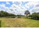 Expansive backyard overlooking a serene pond, enclosed by a black fence at 2214 132Nd E Pl, Parrish, FL 34219