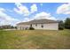 Wide view of fenced backyard with well maintained grass, a covered patio, and landscaping at 2214 132Nd E Pl, Parrish, FL 34219