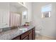 Bathroom featuring granite counters, a window and wood cabinets at 2214 132Nd E Pl, Parrish, FL 34219