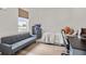 Bedroom with a bed, desk, and futon, complete with a large window at 2214 132Nd E Pl, Parrish, FL 34219