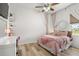 Bedroom with a pink theme, decor and lots of natural light from a large window at 2214 132Nd E Pl, Parrish, FL 34219