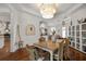 Bright dining room featuring a chandelier, wood table, wicker chairs, and white walls for a relaxed dining experience at 2214 132Nd E Pl, Parrish, FL 34219