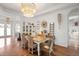 Dining room featuring wood floors, wainscoting and a decorative chandelier at 2214 132Nd E Pl, Parrish, FL 34219