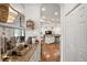 Open hallway leading to kitchen and living area features hardwood floors, white walls, and granite countertops at 2214 132Nd E Pl, Parrish, FL 34219