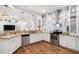 Bright open kitchen featuring white cabinets, granite countertops, stainless steel appliances, and modern light fixtures at 2214 132Nd E Pl, Parrish, FL 34219