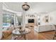 Cozy living room with a cushioned window seat, connecting to outdoor pool and lounge areas, and white sectional sofa at 2214 132Nd E Pl, Parrish, FL 34219