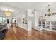 Open concept living room with hardwood floors seamlessly connecting to the kitchen and dining areas at 2214 132Nd E Pl, Parrish, FL 34219