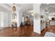 Spacious living room showcasing hardwood floors, white walls, decorative pendant lighting and an open floor plan at 2214 132Nd E Pl, Parrish, FL 34219