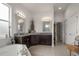 Bright main bathroom with double sinks, dark wood cabinets, and a soaking tub at 2214 132Nd E Pl, Parrish, FL 34219