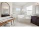 Main bathroom with soaking tub, glass enclosed shower, and double-sink vanity at 2214 132Nd E Pl, Parrish, FL 34219
