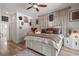 Bright and airy main bedroom with light wood floors, white accents, and ceiling fan at 2214 132Nd E Pl, Parrish, FL 34219