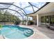 Bright screen enclosed pool area with dining set, outdoor grill and seating at 2214 132Nd E Pl, Parrish, FL 34219