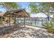 Waterfront patio, featuring a covered area with seating and stunning views of the marina and waterfront at 225 Boca Ciega Dr, Madeira Beach, FL 33708