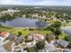 Stunning aerial view of a lakefront home with lush landscaping and a private pool at 2333 Camp Indianhead Rd, Land O Lakes, FL 34639