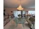 Elegant dining room with crystal chandelier, acrylic chairs and view of the water at 2333 Camp Indianhead Rd, Land O Lakes, FL 34639