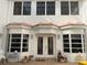 Inviting home entrance with large windows and decorative details at 2333 Camp Indianhead Rd, Land O Lakes, FL 34639