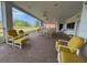 Large outdoor patio with comfortable seating, ceiling fans, and views of a scenic landscape at 2333 Camp Indianhead Rd, Land O Lakes, FL 34639