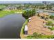 Overhead view of villas nestled by a serene lake and golf course, with city views in the distance at 2421 Lake Point Ln, Clearwater, FL 33762