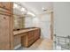 Bathroom featuring a granite countertop, cabinets, large mirror and tile flooring at 2421 Lake Point Ln, Clearwater, FL 33762