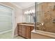 This bathroom features granite counters, wood cabinetry, and tiled shower with a glass surround at 2421 Lake Point Ln, Clearwater, FL 33762
